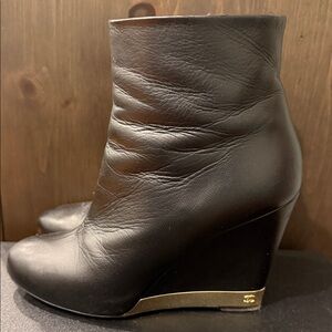 CHANEL Black Leather Wedge Boots with Gold Accent